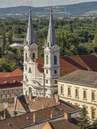View of church towers and surrounding houses with tiled roofs in a picturesque village, esztergom, danube, hungary