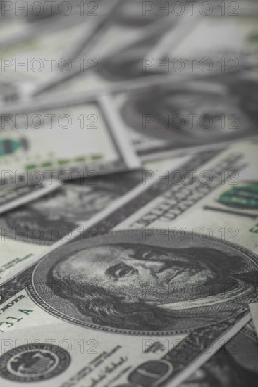 One hundred US dollars bills pile. Selective focus