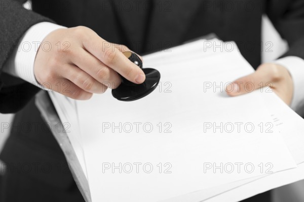 Business men hand hold office paper document stamp