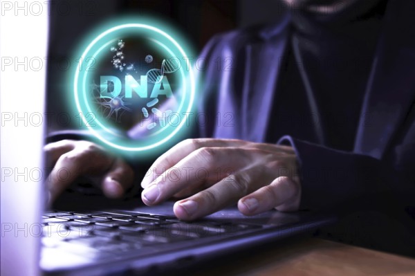 DNA research. Hands of a business man using the computer doing research and work on DNA. Concept of science and research.
