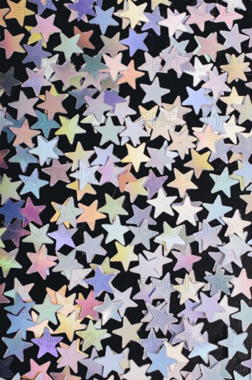 Colorful confetti stars on a dark background