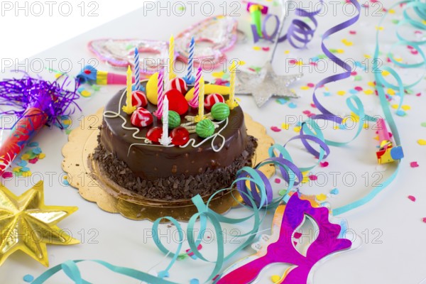 Children birthday party with chocolate cake confetti garland and serpentine
