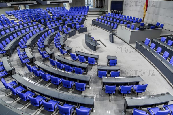 View into the empty plenary chamber of the German Bundestag, plenary chamber with blue chairs arranged in a circle, Reichstag Berlin