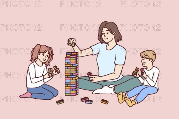 Woman babysitter together with kids plays constructor building tower of children blocks in kindergarten. Little boy and girl have good time and play educational games under supervision of babysitter