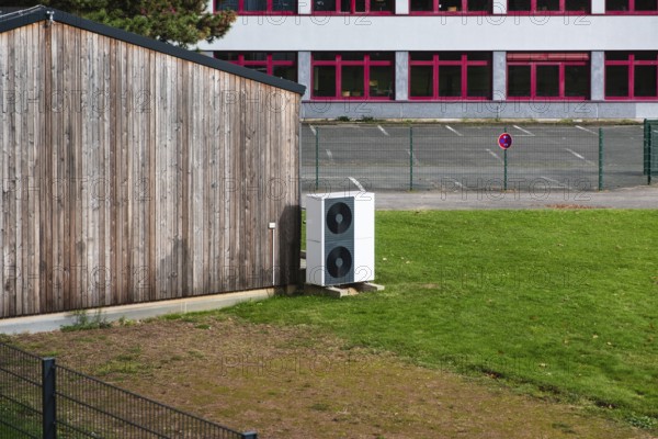 Two stacked heat pumps on a lawn in front of a house, Germany, Europe