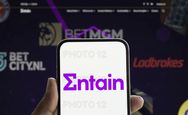 Dhaka, Bangladesh- 28 Nov 2024: Entain logo is displayed on smartphone.Entain plc is an international sports betting and gambling company