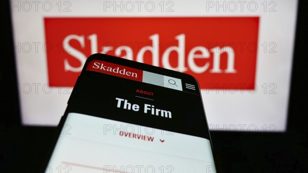 Stuttgart, Germany, 12-17-2023: Mobile phone with website of US law firm Skadden, Arps, Slate, Meagher and Flom LLP in front of logo. Focus on top-left of phone display, Europe