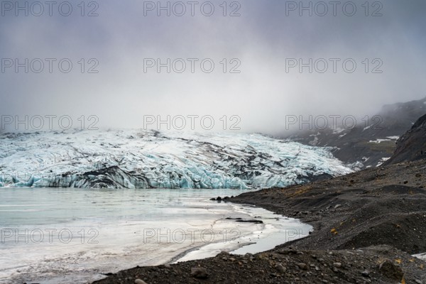 Misty atmosphere enveloping a glacier as it meets the rocky shoreline, iceberg Iceland, glacier, snow, ice rock, ice diamont, glacier lagoon, nature, snow, diamont beach, Iceland, Europe