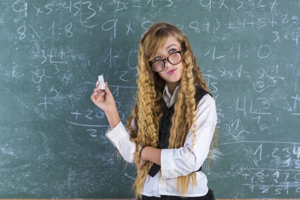 Clever nerd pupil blond girl in green board thinking student schoolgirl