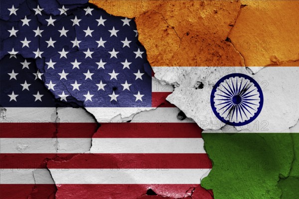 Flags of USA and India painted on cracked wall