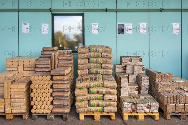 Plastic bags with wood pellets, wood briquettes and firewood at a wholesale market, Allgäu, Bavaria, Germany, Europe