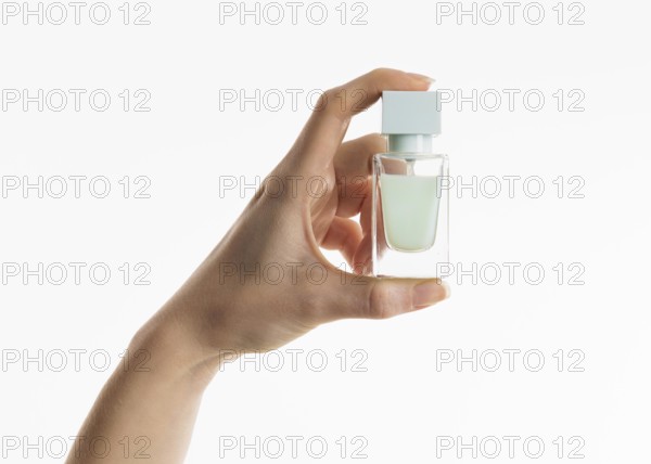Hand holding perfume bottle