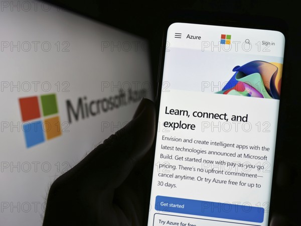 Stuttgart, Germany, 07-11-2023: Person holding smartphone with website of cloud computing platform Microsoft Azure on screen in front of logo. Focus on center of phone display, Europe