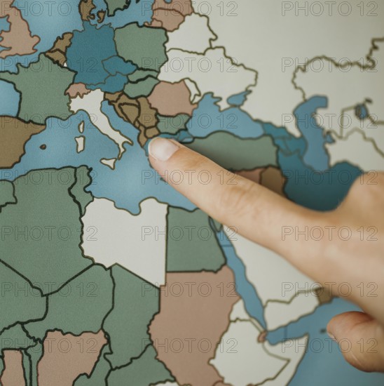 Person pointing europe map