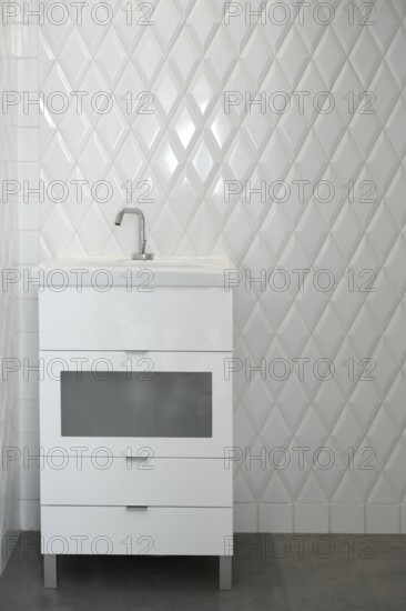 Toilet sink in a white room diamond shape tiles modern vintage bathroom