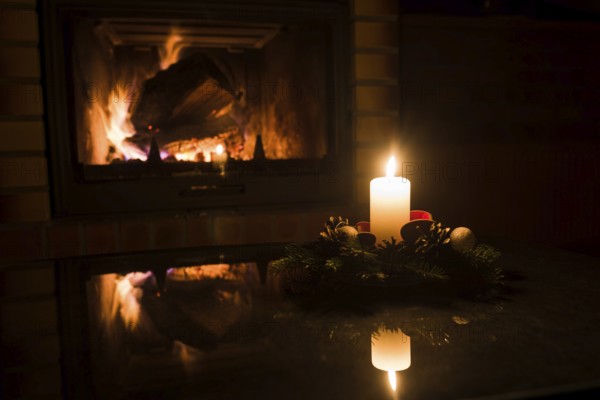 Christmas floral decoration in front of firepace.