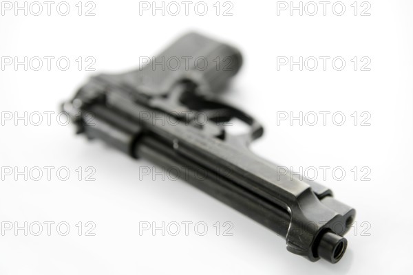 Black hand gun pistol over white background, selective focus, studio shot
