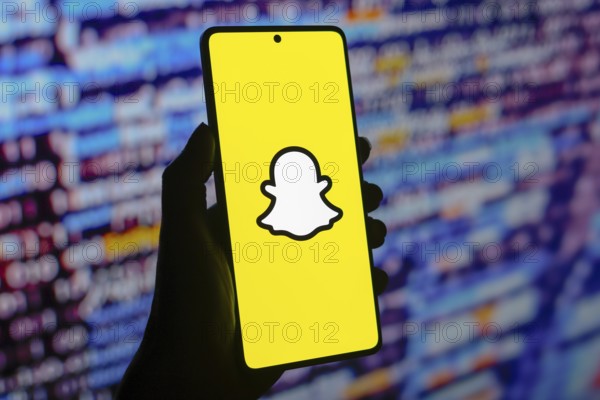 In this photo illustration, the Snapchat logo is displayed on a smartphone screen