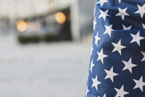 Crop american flag with wrapped person