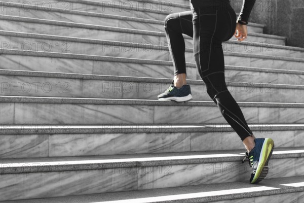 Side view man athletic wear exercising stairs outdoors