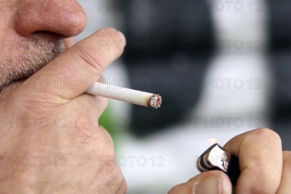 Man lights a cigarette