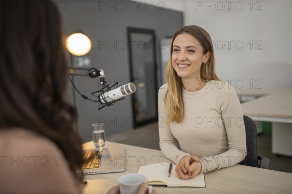 Smiley woman broadcasting interview radio