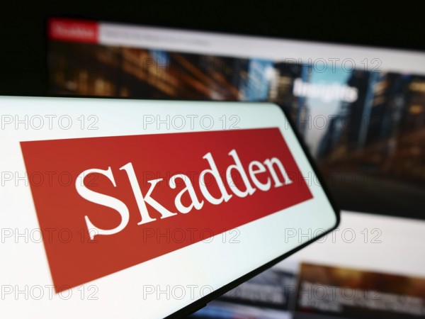 Stuttgart, Germany, 12-17-2023: Smartphone with logo of American law firm Skadden, Arps, Slate, Meagher and Flom LLP in front of website. Focus on center-left of phone display, Europe