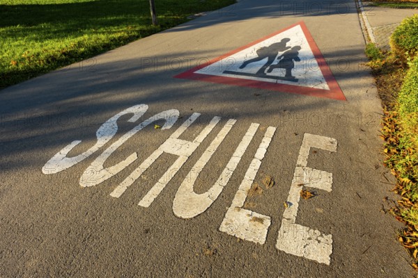 Triangular sign with children and the word SCHOOL on a street in front of the village school, Leimbach, Thurgau, Switzerland, Europe