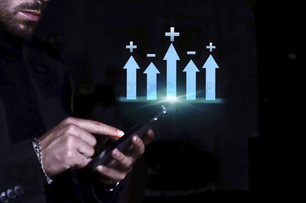 Businessman consulting his mobile phone observing the statistics and monetary balance of his company and the market.
