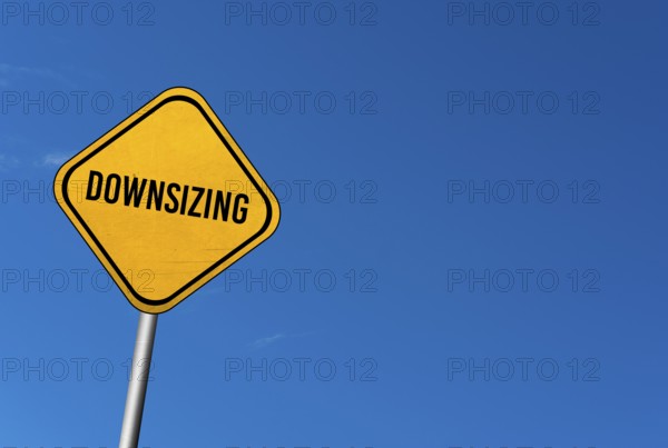 Downsizing, yellow sign with blue sky