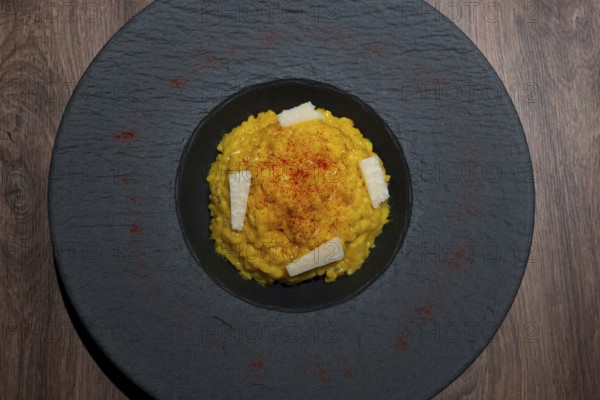 Elegant Plate with Risotto alla Milanese with Saffron and Parmesan Cheese in Lugano, Ticino, Switzerland, Europe