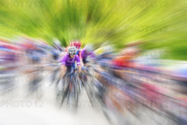Cyclist in sportswear and helmet riding at high speed on a road, race, the motion blur emphasises the speed, Stuttgart, Baden-Württemberg, Germany, Europe
