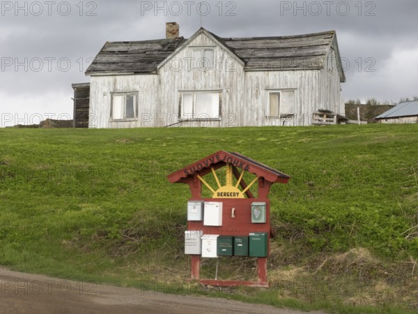 Derelict house on the shore of the Arctic Ocean, beside the town of Nesseby, May, Varangerfjord, Finnmark, Norway, Europe