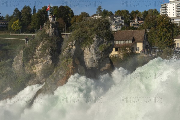 Rhine Falls seen from Laufen Castle, rocky island, Swiss flag, spray, Canton Zurich, on Neuhausen, Switzerland, Europe