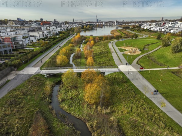 Dortmund, North Rhine-Westphalia, Germany, Phoenix Lake, front of the renaturalised Emscher. The river has been transformed into a near-natural body of water, flood protection and biodiversity through newly designed floodplains. A former industrial wasteland of 99 hectares was transformed into residential, work and leisure areas and 24 hectares of lake surface. In the event of heavy rainfall, the lake acts as a rainwater retention basin. Following the construction of a parallel sewer, the Emscher is now free of wastewater, having previously been an open, above-ground wastewater sewer, combined sewer with surface water and wastewater. The Phoenix Lake, a showcase project for structural change, is an artificial lake on the site of the former Phönix Ost steelworks in Dortmund's Hörde district, Europe