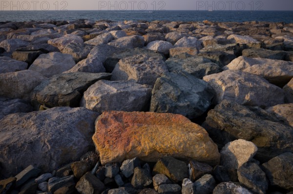 Stones, rocks that form the foundation for the artificial palm island, The Boardwalk, waterfront promenade, Palm Jumeirah, Dubai, United Arab Emirates, VAR, Asia