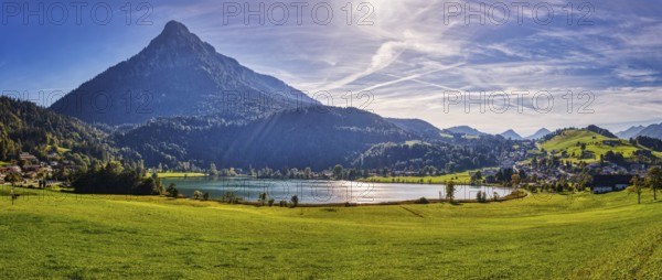 Picturesque alpine scene with a lake surrounded by green meadows and mountains under a clear blue sky, Thiersee, Austria, Europe