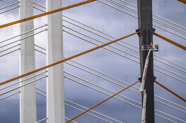 The new Rhine bridge Neuenkamp, the A40, white pillar ropes, and the old motorway bridge, which is being dismantled, preparation for demolition, workers on cherry pickers measure, mark the old bridge pillar, Duisburg, North Rhine-Westphalia, Germany, Europe