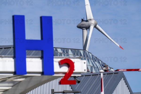 Hydrogen filling station in Antwerp, for cars and lorries, H2 lettering, wind turbine in the harbour, Belgium, Europe