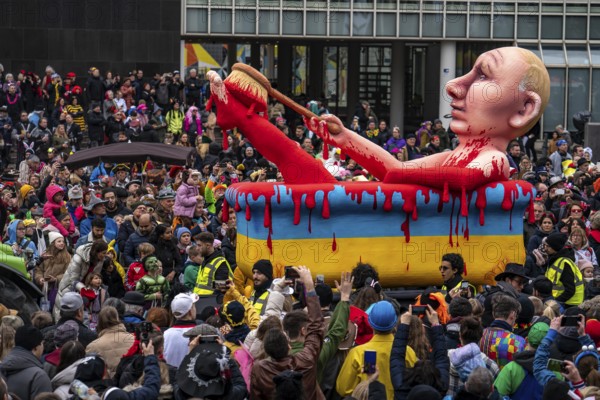 Rose Monday parade in Düsseldorf, street carnival, carnival float, by float builder Jacques Tilly, Vladimir Putin bathes in a bathtub, in the colours of the Ukraine, full of blood