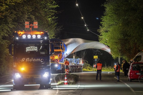 Transport of a 68 metre long, 22 tonne blade of a wind turbine, here in Schwelm, with a self-propelled Blade-Lifter vehicle, over a 40 km long route, over 2 nights, in the Bergisches Land, through towns, villages, over country roads, narrow through roads, to the construction site of the wind turbine near Hagen, North Rhine-Westphalia, Germany, Europe