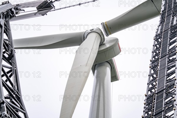 Erection of a wind turbine, wind energy plant, assembly of the third blade, with a crawler lattice crane, wind farm near Hagen, North Rhine-Westphalia, Germany, Europe