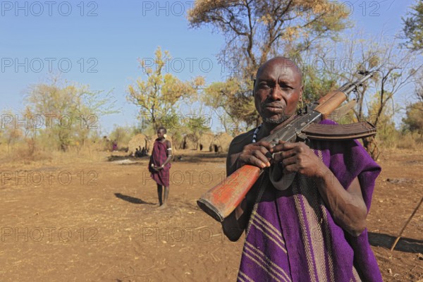 South Ethiopia, in the Maco National Park, in the village of the Mursi, Mursi man with rifle, guard, Ethiopia, Africa