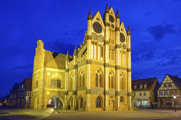 Tangermünde town hall on the market square, surrounded by half-timbered houses, illuminated in the evening. Old town centre of Tangermünde, Hanseatic town in the Altmark. Saxony-Anhalt, Germany, Europe