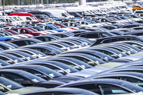 Storage area for new cars in the port of Vlissingen-Oost, vehicles are temporarily stored on over 100 hectares to ship them from Europe to the United Kingdom, Ford cars, others such as models from the Chinese car manufacturer BYD are delivered from here in Europe, wind farm, Netherlands