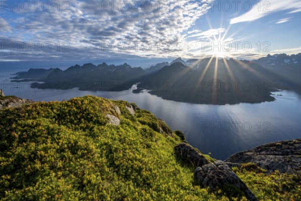 View of Fjord Raftsund and mountains in the evening light, sun star, view from the top of Dronningsvarden or Stortinden, Vesterålen, Norway, Europe