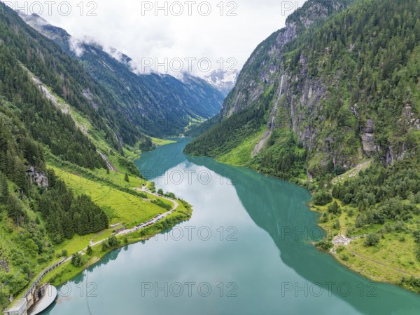 An idyllic mountain lake, surrounded by mountains and lush greenery, under a cloudy sky, Stilluptal, Austria, Germany, Europe