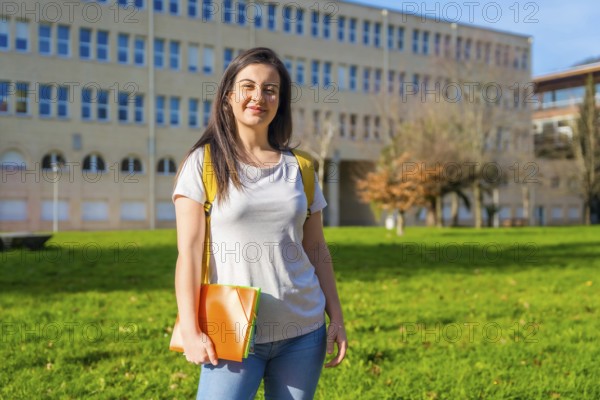 Portrait of a caucasian cheerful student outside the university college