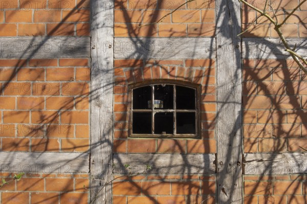 An old rusty window frame of a half-timbered barn, Wildeshauser Geest, Bassum, Diepholz, Lower Saxony, Germany, Europe