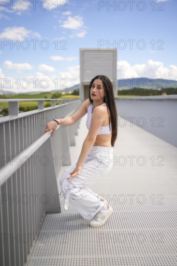Vertical full lengt photo of a young caucasian beauty woman kneeling dancing modern urban music